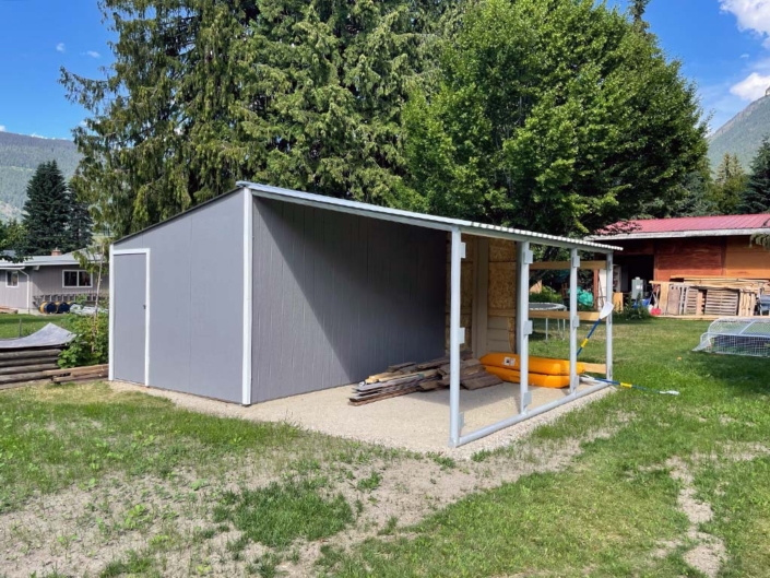 Residential workshop with locking door and lean-to shelter